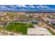 An aerial view of the community park shows the playground, grassy field, and basketball court with mountain views at 22426 N 29Th Pl, Phoenix, AZ 85050