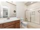 Well-lit bathroom boasting tiled walls, a glass-enclosed shower, and a wooden vanity for a modern feel at 22426 N 29Th Pl, Phoenix, AZ 85050