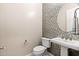 Stylish half-bathroom featuring decorative tile, a modern sink, and fixtures at 22426 N 29Th Pl, Phoenix, AZ 85050