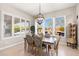 Bright dining room with stylish chandelier and plantation shutters overlooking backyard patio at 22426 N 29Th Pl, Phoenix, AZ 85050