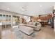 Bright open-concept living room featuring tile flooring, neutral decor, and seamless access to the outdoor patio at 22426 N 29Th Pl, Phoenix, AZ 85050