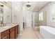 Main bathroom featuring dual sinks, soaking tub and glass enclosed shower at 22426 N 29Th Pl, Phoenix, AZ 85050