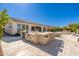 Expansive outdoor kitchen boasts stone accents and ample seating for entertaining on a sunny patio at 22426 N 29Th Pl, Phoenix, AZ 85050