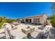 Expansive outdoor living area featuring a large patio, lounge furniture, and a beautiful stone fireplace at 22426 N 29Th Pl, Phoenix, AZ 85050