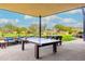 Relax on this covered patio with ping pong table and views of the community green space at 22426 N 29Th Pl, Phoenix, AZ 85050