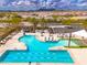 Community pool with a large pool, hot tub, lounge chairs, sunshades, well-maintained landscaping, and mountain views at 22426 N 29Th Pl, Phoenix, AZ 85050