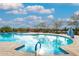 Close-up view of a refreshing community pool with clear blue water, convenient access stairs, and comfortable lounge seating at 22426 N 29Th Pl, Phoenix, AZ 85050