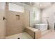 A stylish walk-in shower with built-in bench and soaking tub at 22426 N 29Th Pl, Phoenix, AZ 85050