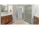 Bright bathroom featuring a glass block partition and double sink vanity with granite countertops at 3025 S Copperwood --, Mesa, AZ 85212