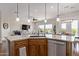 Open kitchen view to living area with granite island, breakfast bar and stainless appliances at 3025 S Copperwood --, Mesa, AZ 85212