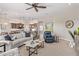 Open-concept living room flowing into kitchen, with comfortable seating and modern decor at 3025 S Copperwood --, Mesa, AZ 85212