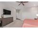 Well-lit main bedroom with a ceiling fan, wall-mounted TV, and neutral tones at 3025 S Copperwood --, Mesa, AZ 85212