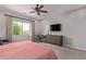 Bright main bedroom with a large window, desk, dresser, and cozy decor at 3025 S Copperwood --, Mesa, AZ 85212