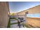 Cozy backyard featuring a modern grill, artificial grass, and clean pavers, perfect for outdoor cooking at 30945 W Picadilly Rd, Buckeye, AZ 85396