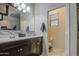 Bathroom featuring dual sinks, a dark wood vanity, and a tiled backsplash at 30945 W Picadilly Rd, Buckeye, AZ 85396