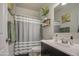 Bathroom featuring a shower/tub combo, a dark wood vanity, and modern decor at 30945 W Picadilly Rd, Buckeye, AZ 85396