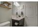 Bright bathroom featuring a dark wood vanity, white cabinets, and framed decor at 30945 W Picadilly Rd, Buckeye, AZ 85396