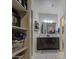 Bathroom featuring a double sink, a dark wood vanity, and lots of storage at 30945 W Picadilly Rd, Buckeye, AZ 85396