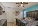 A large bedroom featuring a ceiling fan, large bed, and turquoise accent wall at 30945 W Picadilly Rd, Buckeye, AZ 85396