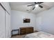 Comfortable bedroom with a modern ceiling fan, flat screen television, and dresser, creating a cozy retreat at 30945 W Picadilly Rd, Buckeye, AZ 85396