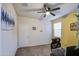 Bedroom with neutral carpet, ceiling fan, and large window providing natural light at 30945 W Picadilly Rd, Buckeye, AZ 85396