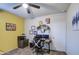 Bright bedroom featuring a ceiling fan, neutral carpet, and a workspace at 30945 W Picadilly Rd, Buckeye, AZ 85396