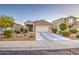 Single-story home with low maintenance desert landscaping and a paved driveway at 30945 W Picadilly Rd, Buckeye, AZ 85396