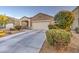 Home with a paved driveway and well-maintained desert landscaping at 30945 W Picadilly Rd, Buckeye, AZ 85396