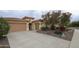 Stylish home with a three-car garage and desert landscaping for curb appeal at 31483 N 133Rd Dr, Peoria, AZ 85383