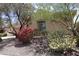 Charming home featuring lush landscaping, desert-friendly plants, trees, and a neutral color palette at 31483 N 133Rd Dr, Peoria, AZ 85383