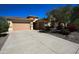 Charming single-story home featuring a tile roof, desert landscaping, and a spacious driveway at 31483 N 133Rd Dr, Peoria, AZ 85383