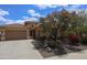 Charming home featuring a private courtyard, stone landscaping, and desert-friendly plants and trees at 31483 N 133Rd Dr, Peoria, AZ 85383