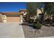 Inviting single-story home featuring a tile roof, well-manicured desert landscaping, and a secure ADT security system at 31483 N 133Rd Dr, Peoria, AZ 85383