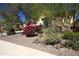 Beautifully landscaped front yard with decorative rock and a variety of colorful desert plants at 31483 N 133Rd Dr, Peoria, AZ 85383