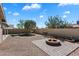 View of a backyard with desert landscaping, a fire pit, a grill, and gardening boxes at 3342 N 63Rd Ave, Phoenix, AZ 85033