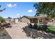 View of a backyard with desert landscaping, patio furniture, and fire pit at 3342 N 63Rd Ave, Phoenix, AZ 85033