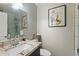 Bathroom with a standup shower, stone countertop sink, and modern wall art at 3342 N 63Rd Ave, Phoenix, AZ 85033