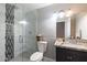 Bathroom featuring a glass shower with gray tile, a white toilet, and a granite sink at 3342 N 63Rd Ave, Phoenix, AZ 85033