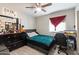 Bedroom with wood-look floors, ceiling fan, and a desk with a computer monitor at 3342 N 63Rd Ave, Phoenix, AZ 85033