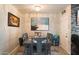 Cozy dining area with a rustic wood table, modern chandelier, and artwork enhancing the space at 3342 N 63Rd Ave, Phoenix, AZ 85033