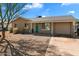 Inviting single-story home featuring desert landscaping, a front patio, and an attached garage at 3342 N 63Rd Ave, Phoenix, AZ 85033