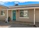 Up close view of the front entry featuring a turquoise door, desert landscaping, and visible house number at 3342 N 63Rd Ave, Phoenix, AZ 85033