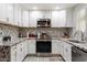 Well-lit kitchen with white cabinetry, granite countertops, stainless steel appliances, and tiled backsplash at 3342 N 63Rd Ave, Phoenix, AZ 85033