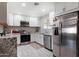 Bright kitchen featuring white cabinets, stainless steel appliances, and granite countertops at 3342 N 63Rd Ave, Phoenix, AZ 85033