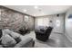 Living room with a stone accent wall, neutral décor, tile floors and comfortable seating arrangement at 3342 N 63Rd Ave, Phoenix, AZ 85033