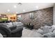 A Stylish living room features a stone accent wall, recessed lighting, and modern furnishings at 3342 N 63Rd Ave, Phoenix, AZ 85033