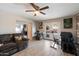 Open living room with tile flooring, French doors, and a ceiling fan, perfect for relaxing and entertaining at 3342 N 63Rd Ave, Phoenix, AZ 85033