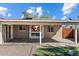 Covered patio with pavers, outdoor fireplace, and view of the back yard at 3342 N 63Rd Ave, Phoenix, AZ 85033