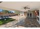 Covered patio with pavers, ceiling fans, outdoor fireplace, and view of backyard at 3342 N 63Rd Ave, Phoenix, AZ 85033