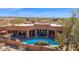 Aerial view of desert home with backyard pool, desert landscaping, and mountain views at 35345 N Canyon Creek Ct, Carefree, AZ 85377